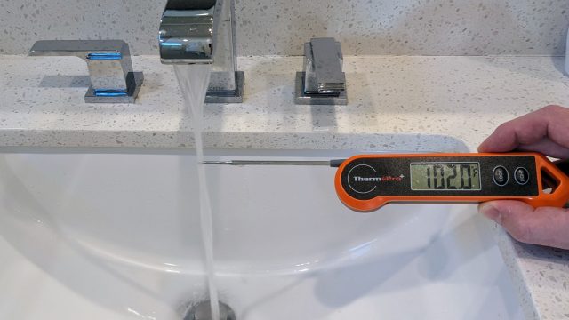 Thermometer showing cold tap water measuring 102°F